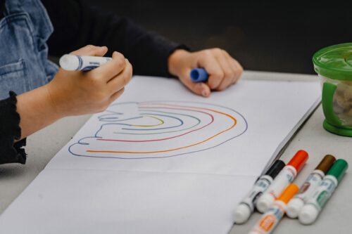 Child drawing a rainbow