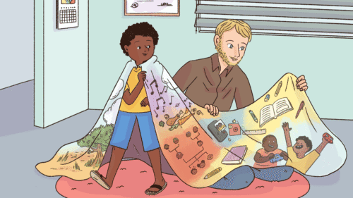 A child wears a colorful blanket of learning themes beside an adult.