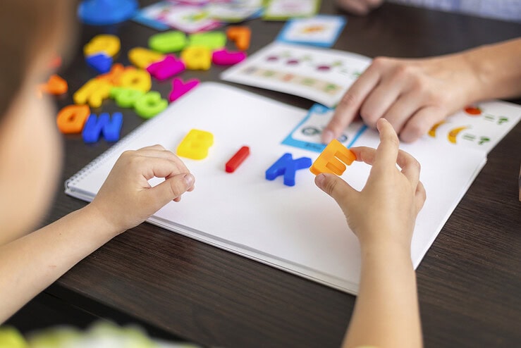 A child is learning how to spell.