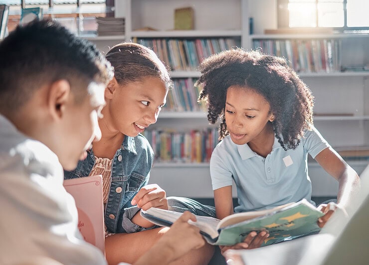 Children browse books together.