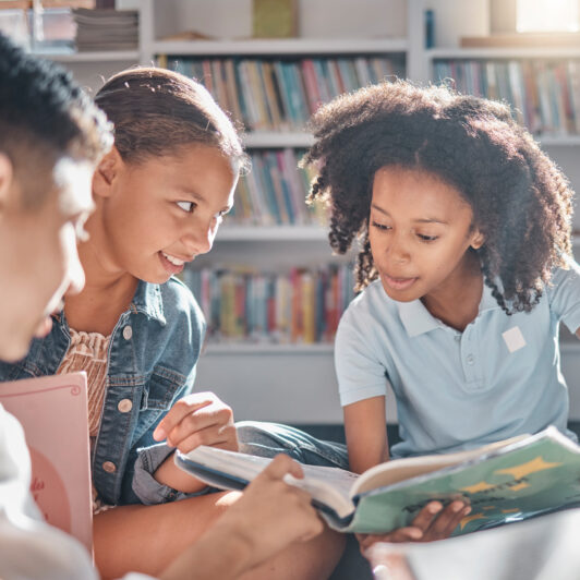 Children browse books together.