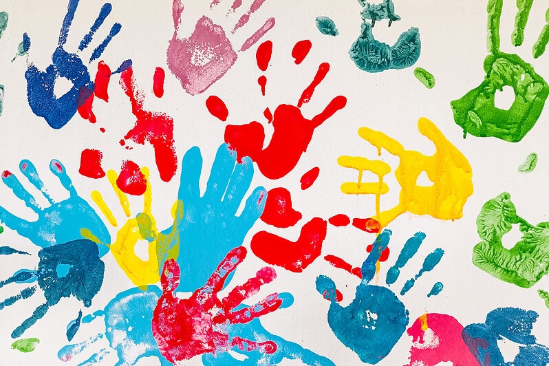 A collection of colourful children's handprints.
