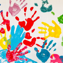 A collection of colourful children's handprints.