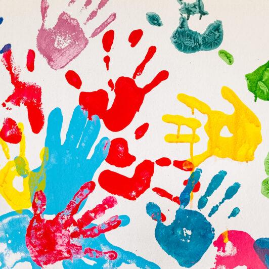 A collection of colourful children's handprints.