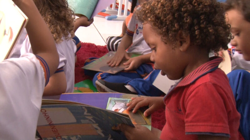 A child reads a book in a classroom.