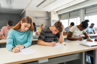 Students sit an exam in school.