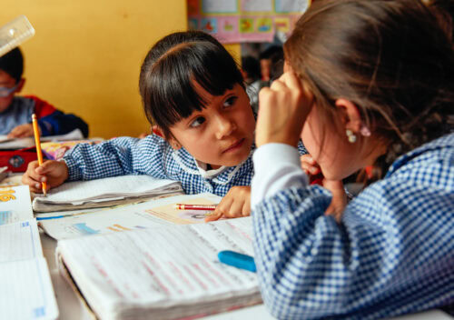 Two young girls learn together.