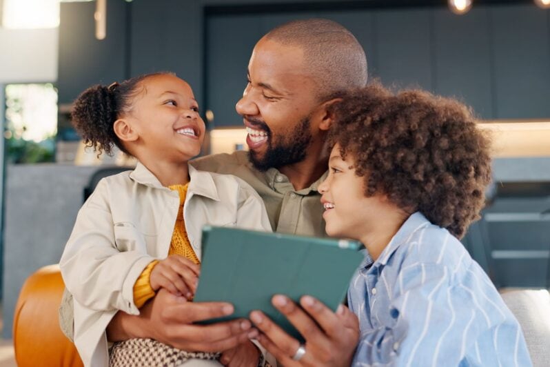 A father and his children laugh together.