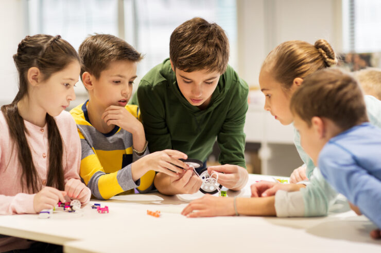 A group of children problem solve together.