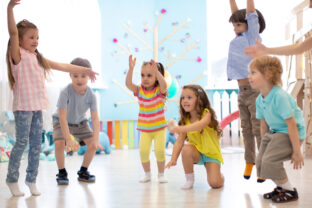 A group of children dance.