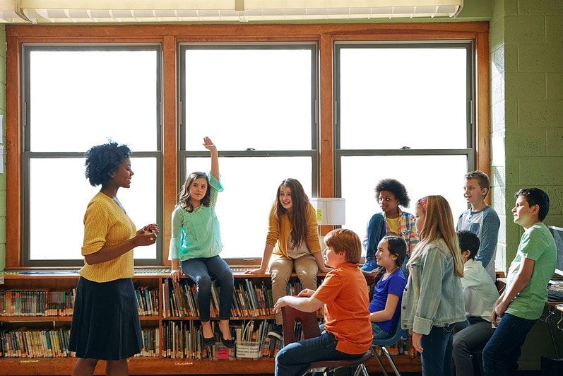 A teacher is leading a discussion with her class.