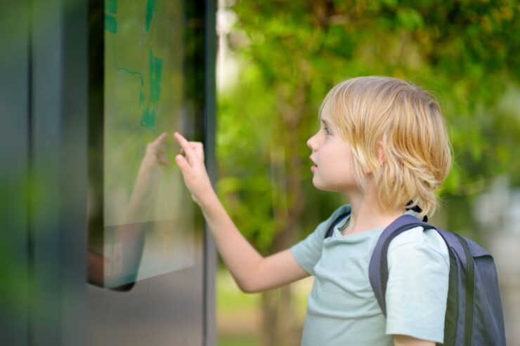 A boy is looking at a map.