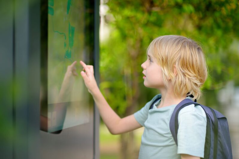 A boy is looking at a map.