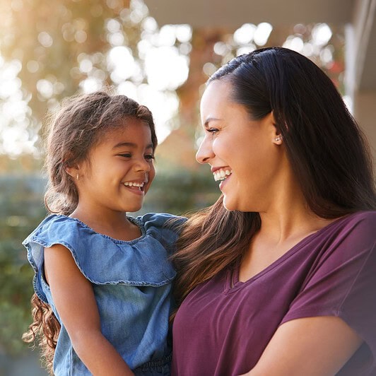 A mother is holder her child.